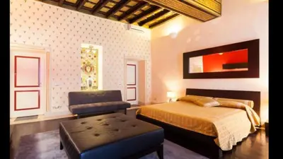 a bedroom with a bed and a chair in it at Grand Master Suites in Rome