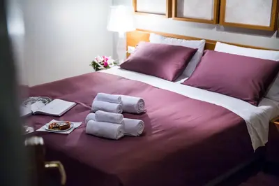 a bed with two towels and a plate of food on it at Grand Master Suites in Rome