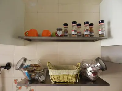 a kitchen counter with bottles and a basket of food at Appartamento di Nina in Rome