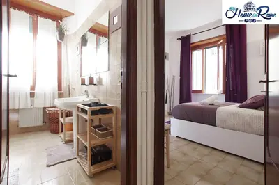 a bedroom with a bed and a bathroom with a sink at Appartamento di Nina in Rome