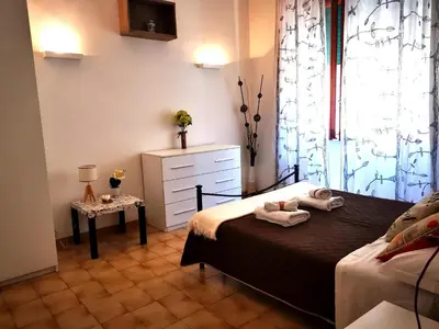 a bedroom with two beds and a dresser and a window at Appartamento di Nina in Rome