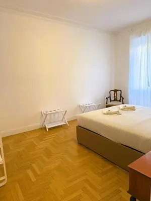 a bedroom with a bed and a wooden floor at Vatican Terrace in Rome