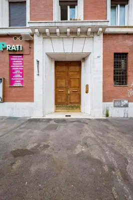 a building with a large wooden door on a street at Vatican Terrace in Rome