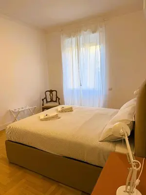 a bedroom with a large bed with a window at Vatican Terrace in Rome