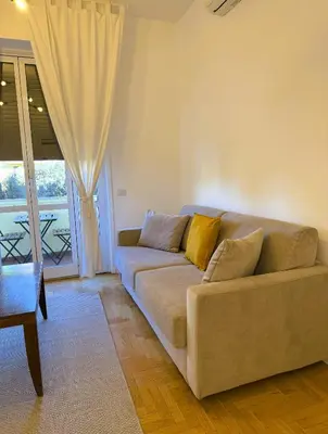 a living room with a couch and a window at Vatican Terrace in Rome