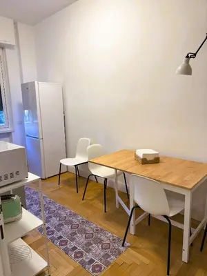 a kitchen with a table and chairs and a refrigerator at Vatican Terrace in Rome