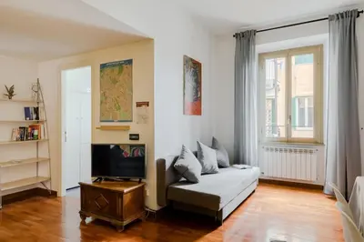 a living room with a couch and a tv at Casa Buonarroti, Rome, City Center, Elegant and Quiet Apartment in Rome