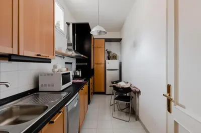 a small kitchen with a sink and a microwave at Casa Buonarroti, Rome, City Center, Elegant and Quiet Apartment in Rome