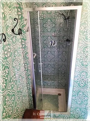 a shower with a mirror in a bathroom at Il Quartierino in Rome