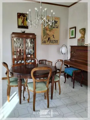 a dining room with a table and a piano at Il Quartierino in Rome