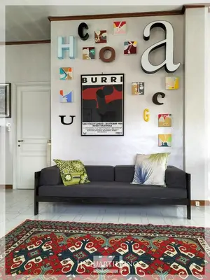 a living room with a couch and a rug at Il Quartierino in Rome
