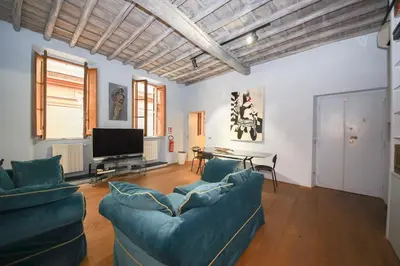 a living room with two blue couches and a television at 500m from Piazza di Spagna - Canova Home by Hôtea in Rome