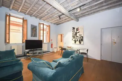 a living room with two blue couches and a television at 500m from Piazza di Spagna - Canova Home by Hôtea in Rome