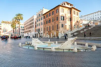 a fountain in the middle of a street with buildings at 500m from Piazza di Spagna - Canova Home by Hôtea in Rome