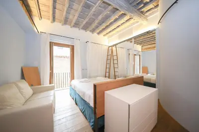 a bedroom with a bed and a couch in a room at 500m from Piazza di Spagna - Canova Home by Hôtea in Rome