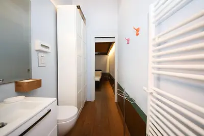 a bathroom with a white toilet and a sink at 500m from Piazza di Spagna - Canova Home by Hôtea in Rome
