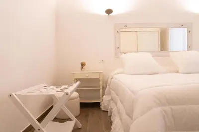 a white bedroom with two beds and a desk at Domus Machiavelli in Rome