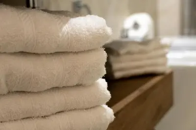 a stack of white towels sitting on a counter in a bathroom at Domus Machiavelli in Rome