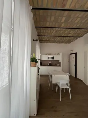 a kitchen and dining room with a table and chairs at Domus Machiavelli in Rome