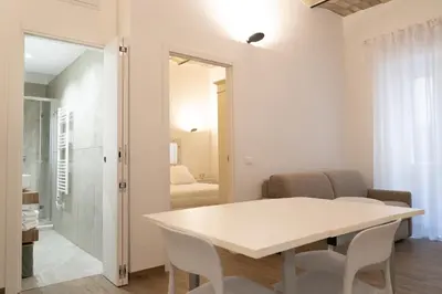 a white dining room with a white table and chairs at Domus Machiavelli in Rome