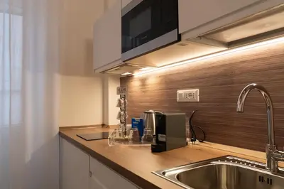 a kitchen with a sink and a microwave at Domus Machiavelli in Rome
