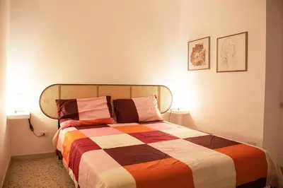 a bedroom with a bed with a colorful blanket at Casa Marini in Rome