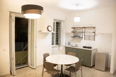 a kitchen with a table and chairs in a room at Casa Marini in Rome