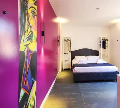 a bedroom with a bed and a surfboard at Prisma Rooms in Rome