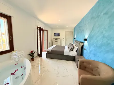 a bedroom with a bed and a tub and a sink at ROME PLACE guest house in Rome