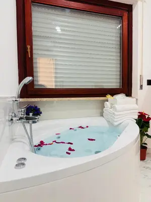 a bathroom with a bath tub with a window at ROME PLACE guest house in Rome