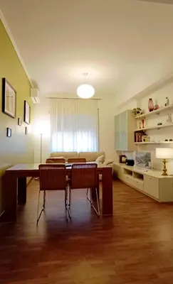 a living room with a dining room table and chairs at Nico's Apartment in Rome