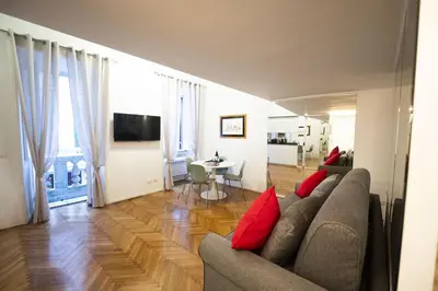 a living room with a couch and red pillows at Lovely Nest With Balcony by The Spanish Steps in Rome