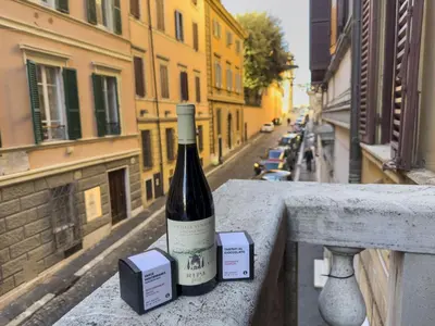 a bottle of wine sitting on a ledge at Lovely Nest With Balcony by The Spanish Steps in Rome