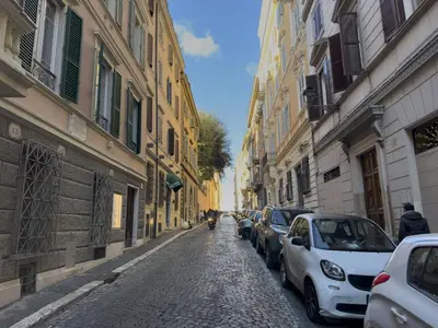 a street with cars parked on a cobblestone street at Lovely Nest With Balcony by The Spanish Steps in Rome
