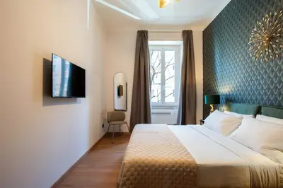 a hotel room with a bed and a television at Confort Collection Trastevere in Rome