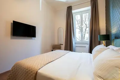 a bedroom with a white bed and a window at Confort Collection Trastevere in Rome
