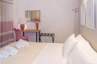 a bedroom with a bed with towels on it at Le Libellule apartment in Rome