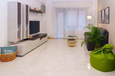 a living room with a flat screen tv and a couch at Le Libellule apartment in Rome