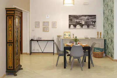 a dining room with a table and chairs at Le Libellule apartment in Rome