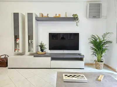 a living room with a large flat screen tv at Le Libellule apartment in Rome