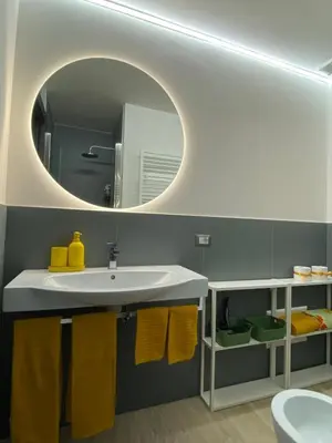 a bathroom with a sink and a mirror at Villino Ancillotto with garden and parking motorcycle space in Rome
