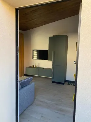 an open door to a kitchen with a refrigerator at Villino Ancillotto with garden and parking motorcycle space in Rome