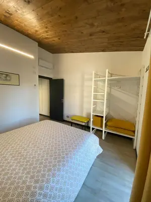 a bedroom with a bed and bunk beds in it at Villino Ancillotto with garden and parking motorcycle space in Rome