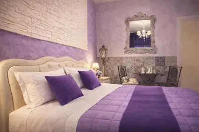 a purple bedroom with a large bed with purple pillows at RomAntic Dreams in Rome
