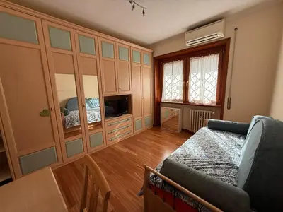 a living room with a couch and a tv at Apartment in the heart of EUR in Rome