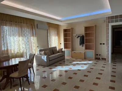 a living room with a couch and a table at Apartment in the heart of EUR in Rome