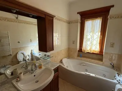 a bathroom with a tub and a sink and a bath tub at Apartment in the heart of EUR in Rome