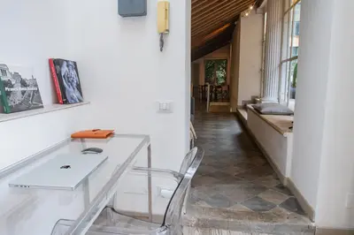 a dining room with a glass table and a chair at Historical Palace Apartment with Large Terrace in Rome