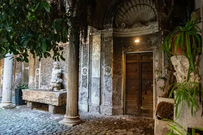 a building with a door with a statue on it at Historical Palace Apartment with Large Terrace in Rome
