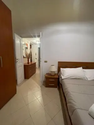a bedroom with a large bed and a hallway at Termini Station Turati House by Dama in Rome
